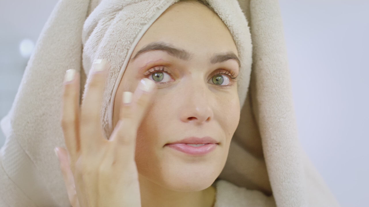 Woman applying skincare cream